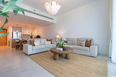 a living room with two couches and a table at Beachfront Stay with Full Sea Views, Walking Distance to The Walk, JBR Beach, and Dubai Marina - La Vie, Jumeirah Beach Residence by Deluxe Holiday Homes in Dubai