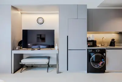 a kitchen with a washer and dryer in a room at TRPS - MAG EYE 970, MBR - Modern and Cozy Studio, Furnished, MBR Living in Dubai