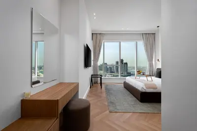 a bedroom with a bed and a large window at Maison Privee - High-Floor Haven with Open Sea Views on Palm Entry in Dubai