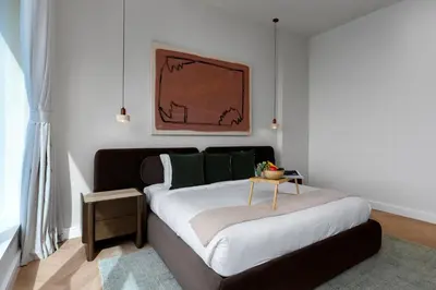 a bedroom with a bed with a table on it at Maison Privee - High-Floor Haven with Open Sea Views on Palm Entry in Dubai