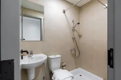 a bathroom with a toilet and a sink at Maison Privee - High-Floor Haven with Open Sea Views on Palm Entry in Dubai