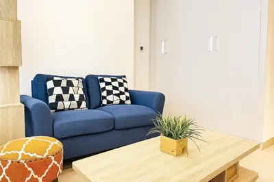 a blue couch in a living room with a coffee table at Elegant Studio in JVC in Dubai