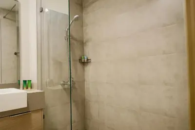 a bathroom with a shower and a sink at Elegant Studio in JVC in Dubai