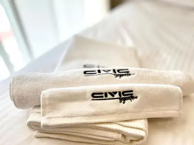 a pile of towels sitting on top of a bed at Elegant Studio in JVC in Dubai