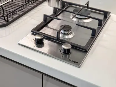 a stove top oven sitting on top of a kitchen counter at Livin' Holidays - Studio - Riviera Elegance in Dubai
