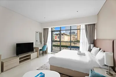 a hotel room with a bed and a large window at Stylish Studio with Rooftop Pool on the Palm in Dubai