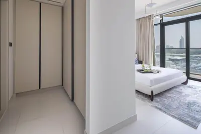 a bedroom with a bed and a large window at Frank Porter - Marina Vista Tower 1 in Dubai