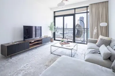 a living room with a couch and a tv at Frank Porter - Marina Vista Tower 1 in Dubai