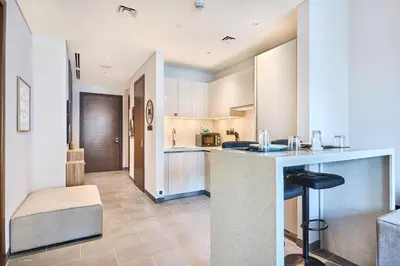 a kitchen with a counter and a sink in a room at STAY BY LATINEM Luxury 1BR plus study Holiday Home CC 2408 in Dubai