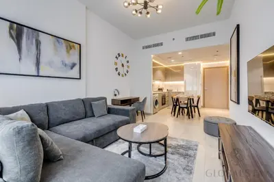a living room with a couch and a table at GlobalStay 1 Bedroom Apartment for 4 Guests Azizi Riviera 42 Dubai in Dubai