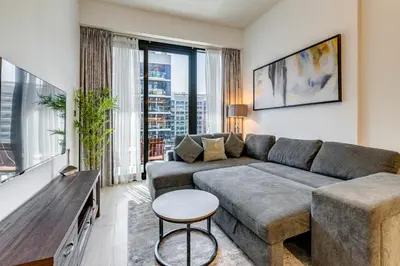 a living room with a couch and a table at GlobalStay 1 Bedroom Apartment for 4 Guests Azizi Riviera 42 Dubai in Dubai