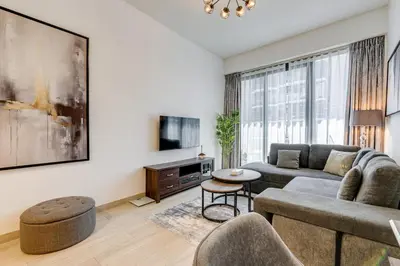 a living room with a couch and a tv at GlobalStay 1 Bedroom Apartment for 4 Guests Azizi Riviera 42 Dubai in Dubai
