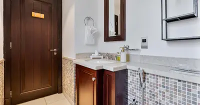 a bathroom with a sink and a mirror at Downtown 2BHK Iconic Burj Khalifa Views in Dubai