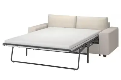 a bed frame with a mattress and a chair at Downtown 2BHK Iconic Burj Khalifa Views in Dubai