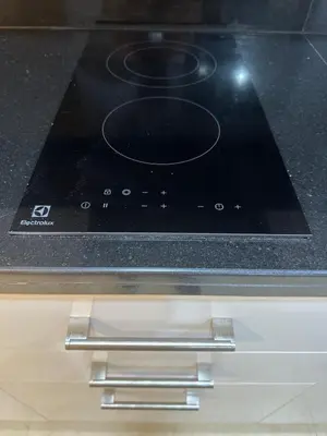 a black stove top oven sitting on top of a counter at Cozy & Stylish Studio in Silicon Oasis in Dubai