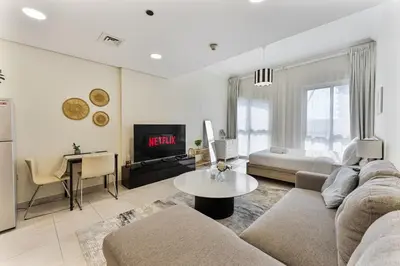 a living room with a couch and a table at Splendid Studio near Canal & famous Golf Clubs in Dubai