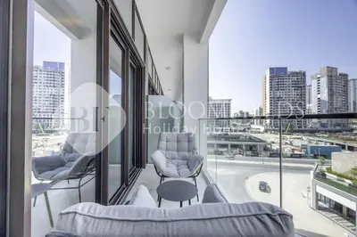 a room with a view of a city at Bloomfields Lumière Stu Azizi Riviera in Dubai