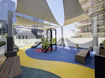 a playground in a building with two benches at Bloomfields Lumière Stu Azizi Riviera in Dubai
