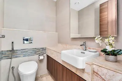 a bathroom with a sink and a toilet at GuestReady - High-Floor 2BR | City and Canal View in Dubai