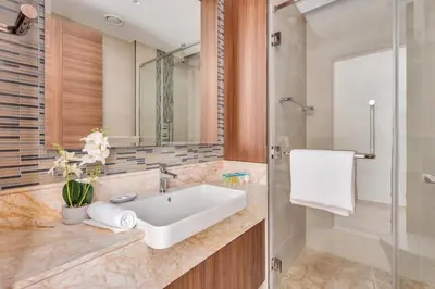 a bathroom with a sink and a shower at GuestReady - High-Floor 2BR | Canal and City View in Dubai