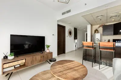 a living room with a large television and a table at 2b Stylish apart in JBR, near Beach&Marina Walk in Dubai