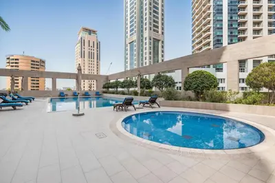 a swimming pool in a city with tall buildings at 2b Stylish apart in JBR, near Beach&Marina Walk in Dubai
