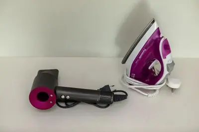 a hair dryer and a phone on a counter at 2b Stylish apart in JBR, near Beach&Marina Walk in Dubai