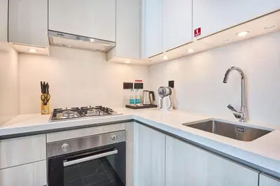 a kitchen with a sink and a stove at STAY BY LATINEM Luxury 1BR Holiday Home CC 3313 Near Burj Khalifa in Dubai