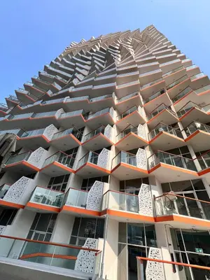 a tall apartment building with balconies on it at Binghatti Millennium Studio Apartment in Dubai