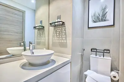 a bathroom with a white sink and a mirror at Modern Studio in Studio One Tower, Dubai Marina in Dubai