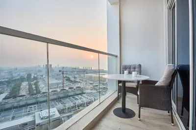 a balcony with a table and chairs and a view of a city at Modern Studio in Studio One Tower, Dubai Marina in Dubai