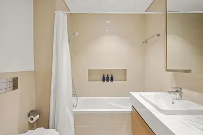 a bathroom with a tub and a sink and a shower at VayK - Spacious 2BR in Dubai Creek Harbour in Dubai