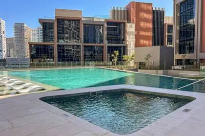 a large swimming pool in the middle of a city at Peninsula Five Luxurious Business Bay Studio in Dubai