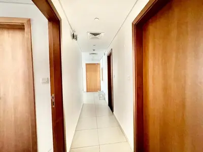 a corridor of a hallway with a long hallway at Perfect choice for a big family in Dubai