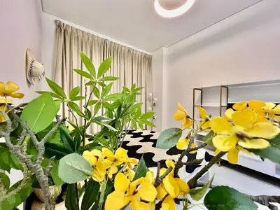 a living room with yellow flowers and a couch at Karama Apple building in Dubai