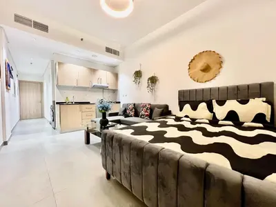 a bedroom with a large bed with a zebra blanket at Karama pretty unit near metro in Dubai