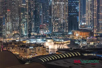 a view of a city at night with lights at SML Vacation Homes at Vida Dubai Mall - Apartments with Burj Khalifa Views & access to the Dubai Mall in Dubai