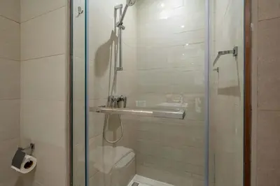 a bathroom with a shower with a glass door at Stylish Studio with Gym & Pool in Azizi Riviera in Dubai