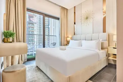 a bedroom with a large white bed and a window at STAY BY LATINEM Luxury 1BR Holiday Home CC 1806 Near Burj Khalifa in Dubai