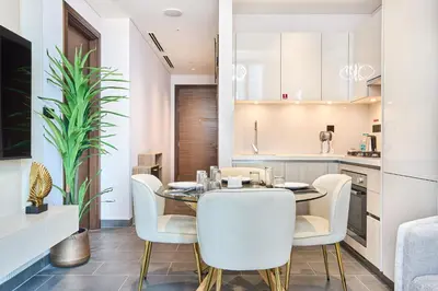 a kitchen and dining room with a table and chairs at STAY BY LATINEM Luxury 1BR Holiday Home CC 1806 Near Burj Khalifa in Dubai