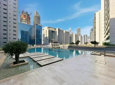 a pool in the middle of a city with buildings at Beautiful Canal View Majestine Damac in Dubai