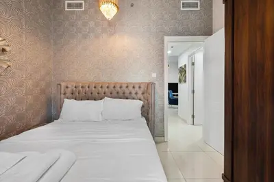 a bedroom with a bed and a hallway at Spacious 2 Bedroom Apartment in JBR in Dubai