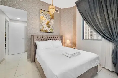 a bedroom with a large white bed in a room at Spacious 2 Bedroom Apartment in JBR in Dubai