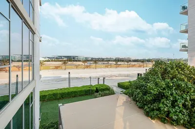 a balcony of a building with a view of a beach at Elegant 1 Bedroom Apartment with Balcony & Lagoon in District One in Dubai