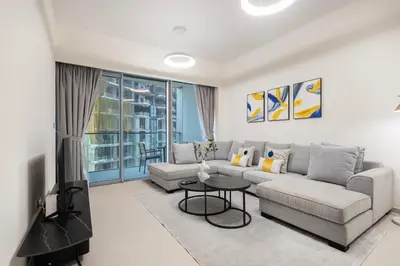 a living room with a couch and a table at Grande Residence, Downtown - 1 Bedroom Apartment - Allsopp & Allsopp in Dubai