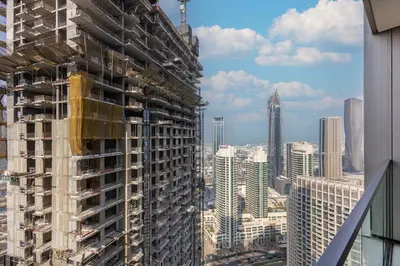a tall building under construction in a city at Grande Residence, Downtown - 1 Bedroom Apartment - Allsopp & Allsopp in Dubai