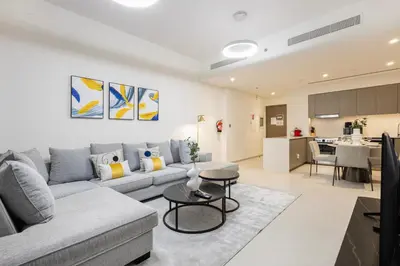 a living room with a couch and a table at Grande Residence, Downtown - 1 Bedroom Apartment - Allsopp & Allsopp in Dubai