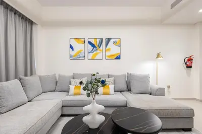 a living room with a couch and a table at Grande Residence, Downtown - 1 Bedroom Apartment - Allsopp & Allsopp in Dubai