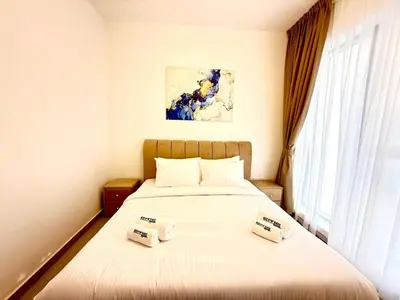 a bedroom with a bed with two towels on it at Majestic 2 BHK Park view at Liwan 2- Dubai in Dubai