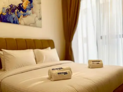 a bed with two folded towels on top of it at Majestic 2 BHK Park view at Liwan 2- Dubai in Dubai